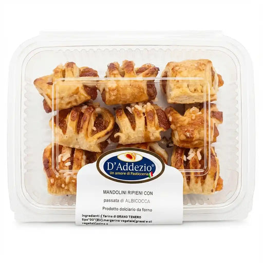 Mandolini D'Addezio puff pastries with apricot heart, presented in a tray and sprinkled with sugar.