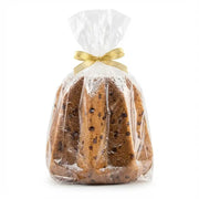 Italian pandoro with chocolate chips wrapped in a transparent bag with a golden ribbon