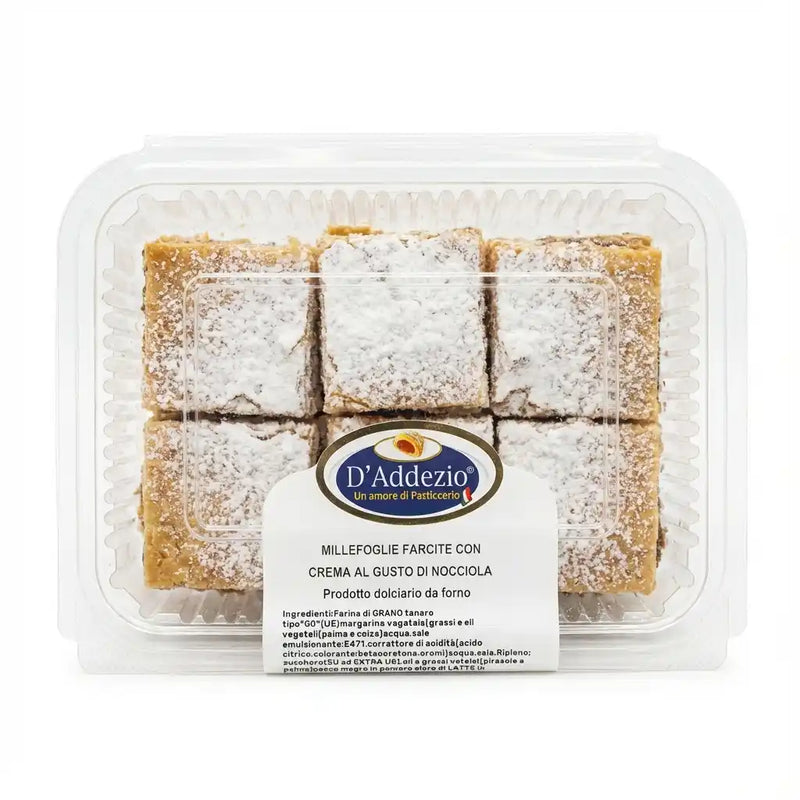Millefoglie D'Addezio in a transparent container, Italian puff pastry in powdered sugar portions.